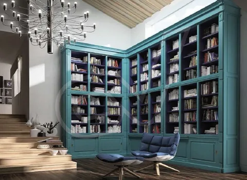 Librería de gran altura en color turquesa que recorre dos paredes de una sala de lectura