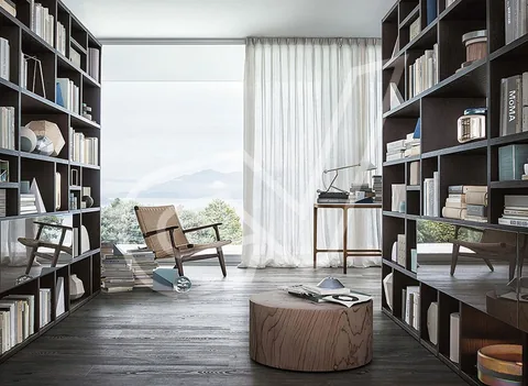 Librería en tono oscuro de suelo a techo en una sala de lectura