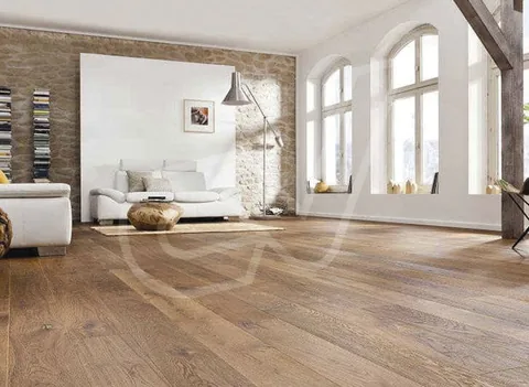 Suelo de madera en tono roble en un salón con pared de ladrillo
