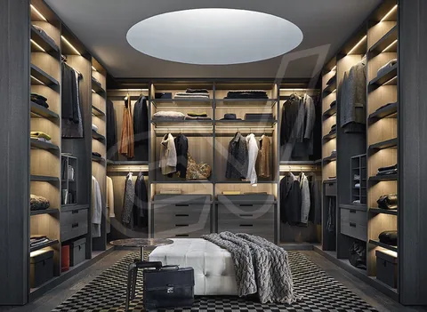 Vestidor oscuro con iluminación indirecta y módulos acristalados
